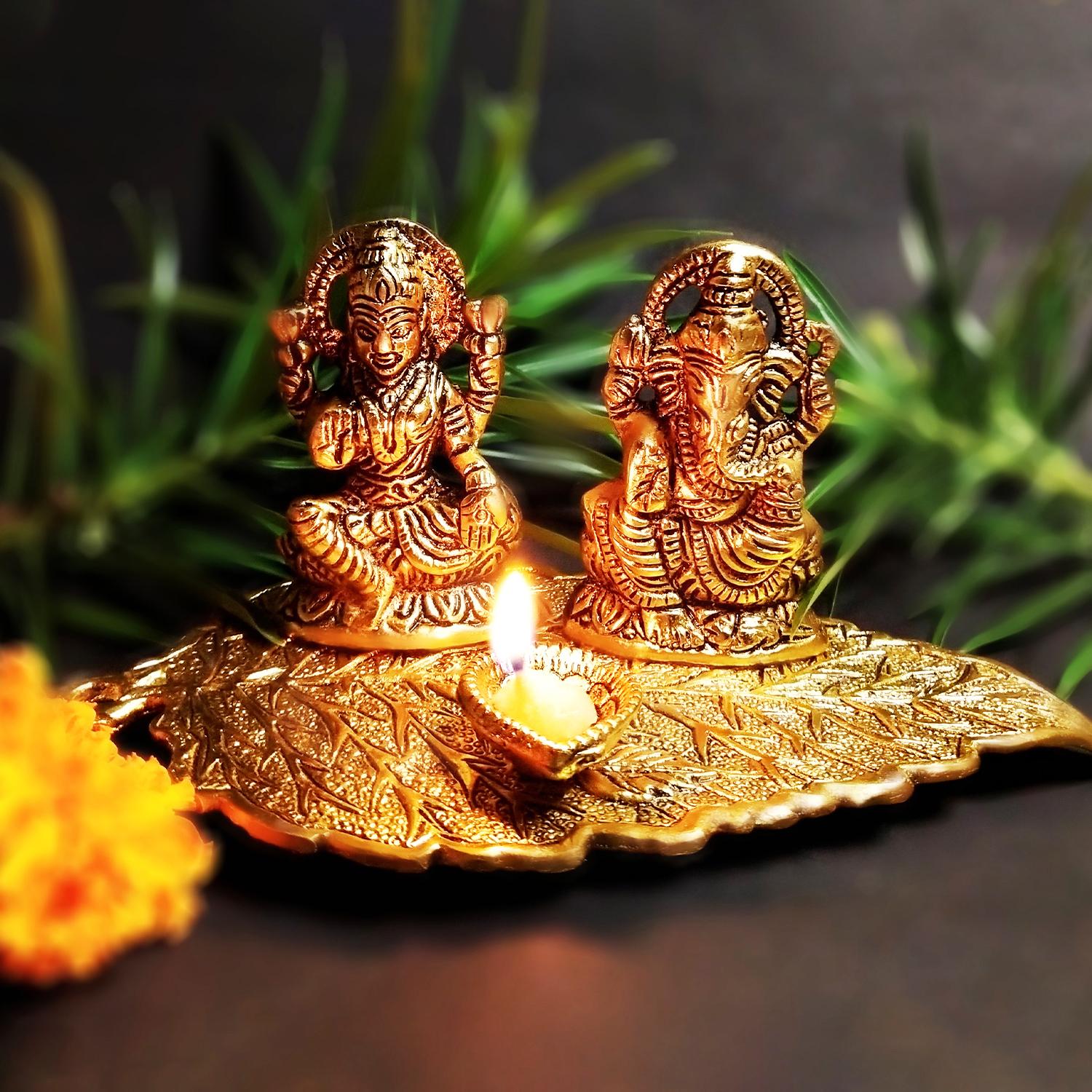 Golden Laxmi Ganesh On Leaf With Diya |